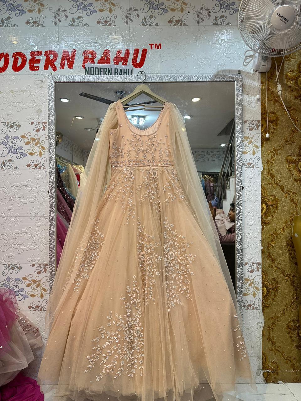 Elegant Peach Net Gown with Floral Sequin Embroidery & Floor-Length Cape Sleeves – Engagement & Party Wear