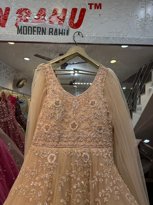 Elegant Peach Net Gown with Floral Sequin Embroidery & Floor-Length Cape Sleeves – Engagement & Party Wear