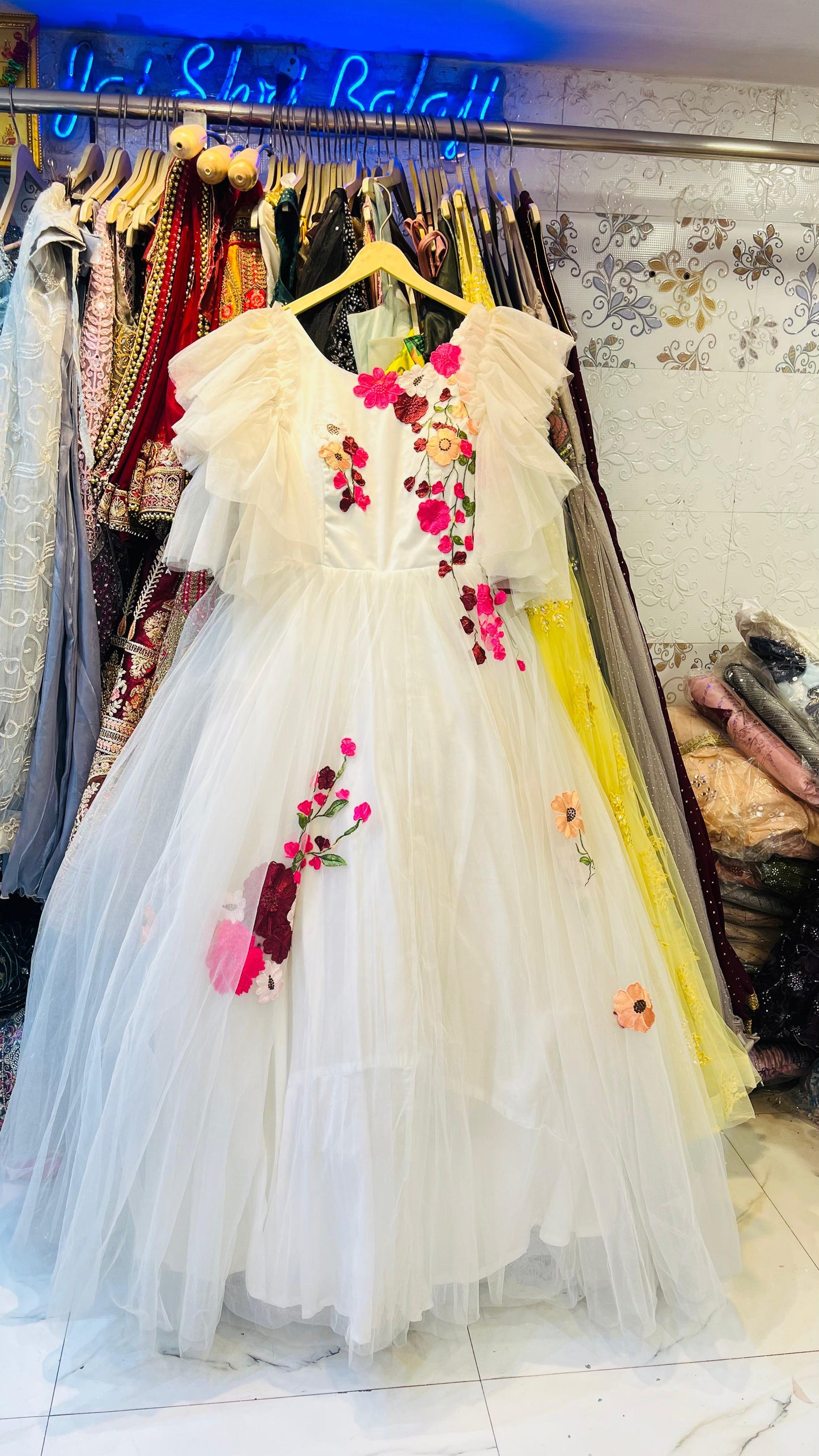 Whimsical White Tulle Ball Gown with Colorful Floral Embroidery & Ruffled Angel Sleeves – Garden Party Wear